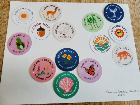 14 different round stickers highlighting all the different libraries in the SLO County system