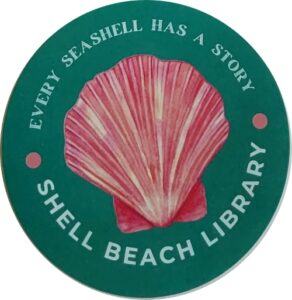 green circle with a pink shell in the middle encircled by the words "EVERY SEASHELL HAS A STORY * SHELL BEACH LIBRARY"